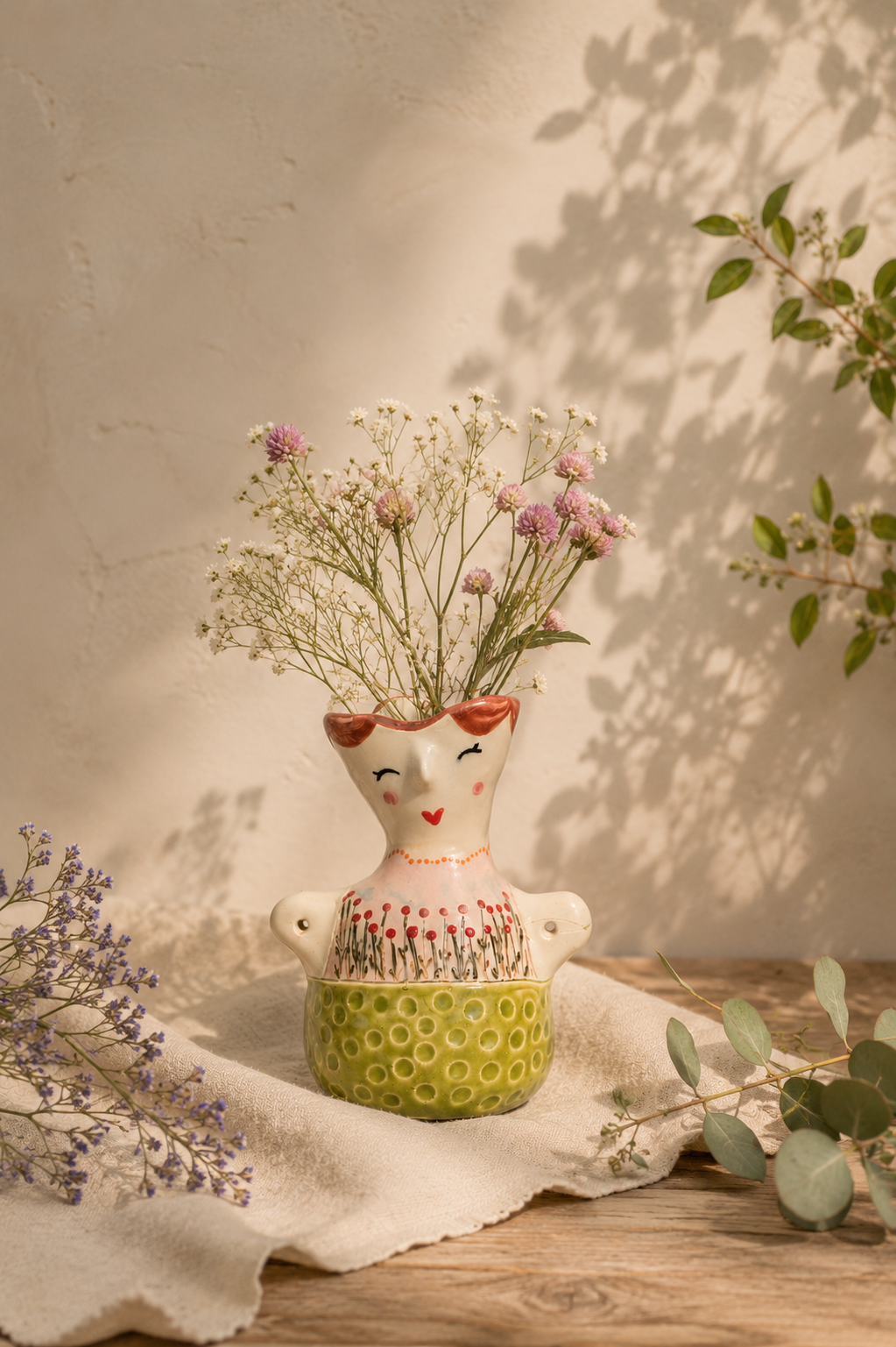 A smiling ceramic guardian with flowers