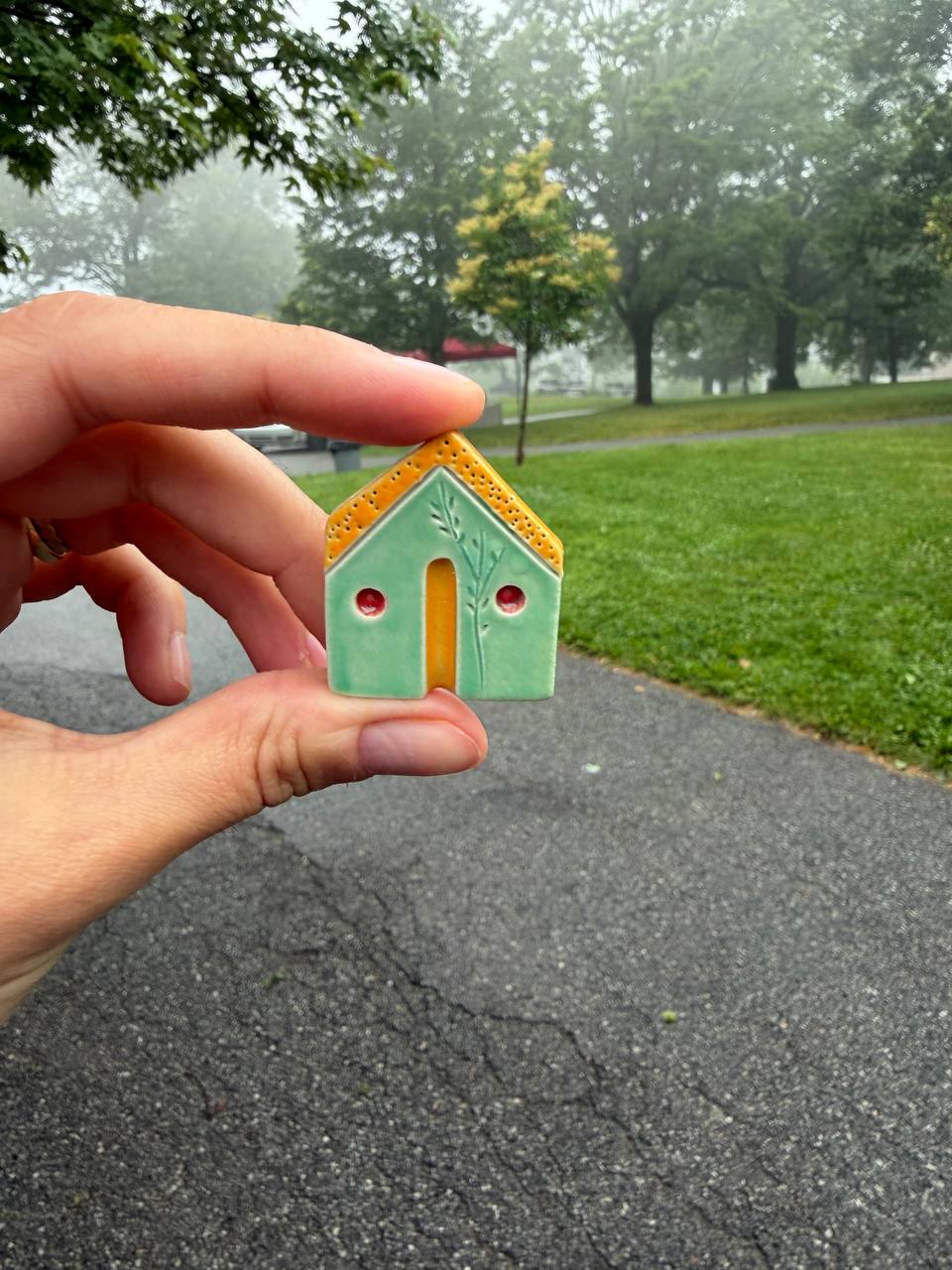 Small ceramic house among details of the surrounding environment